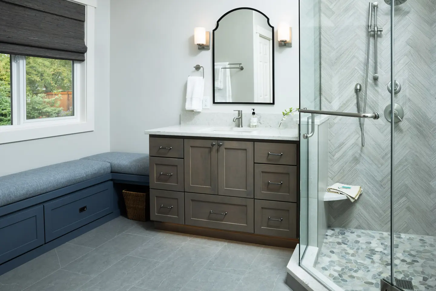 Luxury primary bathroom with herringbone-tiled shower